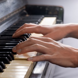 Hands playing the piano